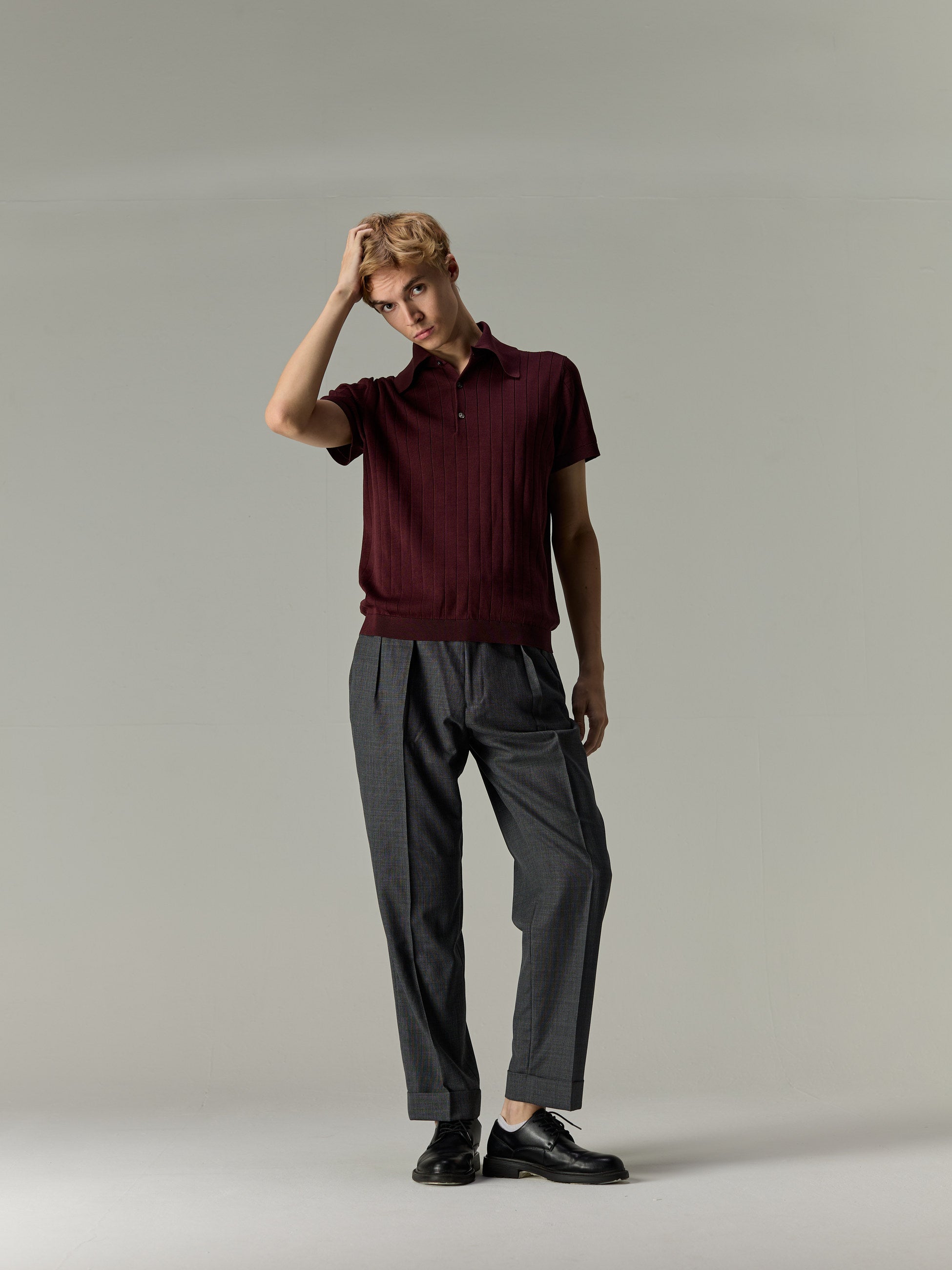 Burgundy — The Classic Polo, styled with grey pleated trousers